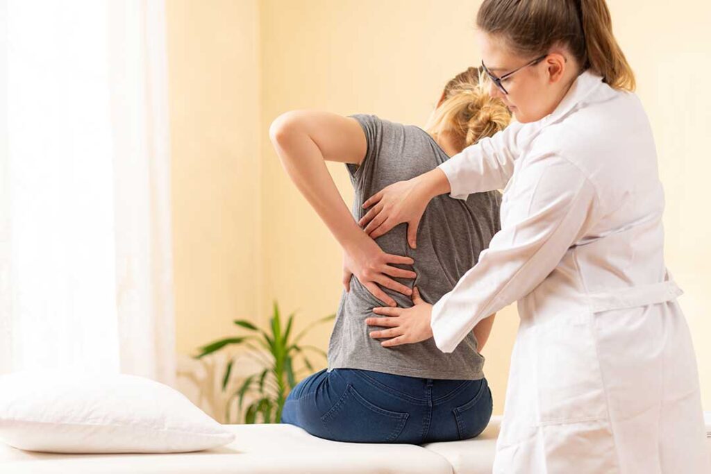 Person sleeping on their side with a pillow between their knees and neck aligned on a supportive pillow.